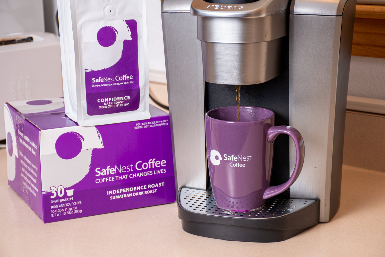 SafeNest pod box and bag of coffee beans next to a kerig brewing coffee into a cup.